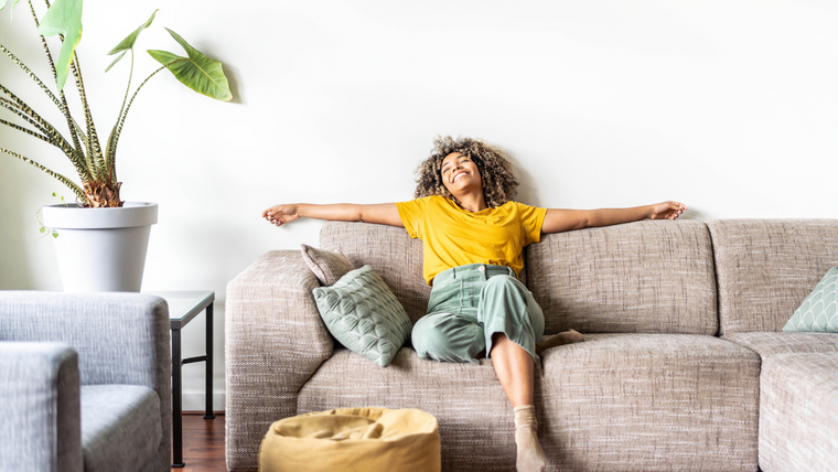 Woman relaxing on the sofa breathing clean air free from hayfever